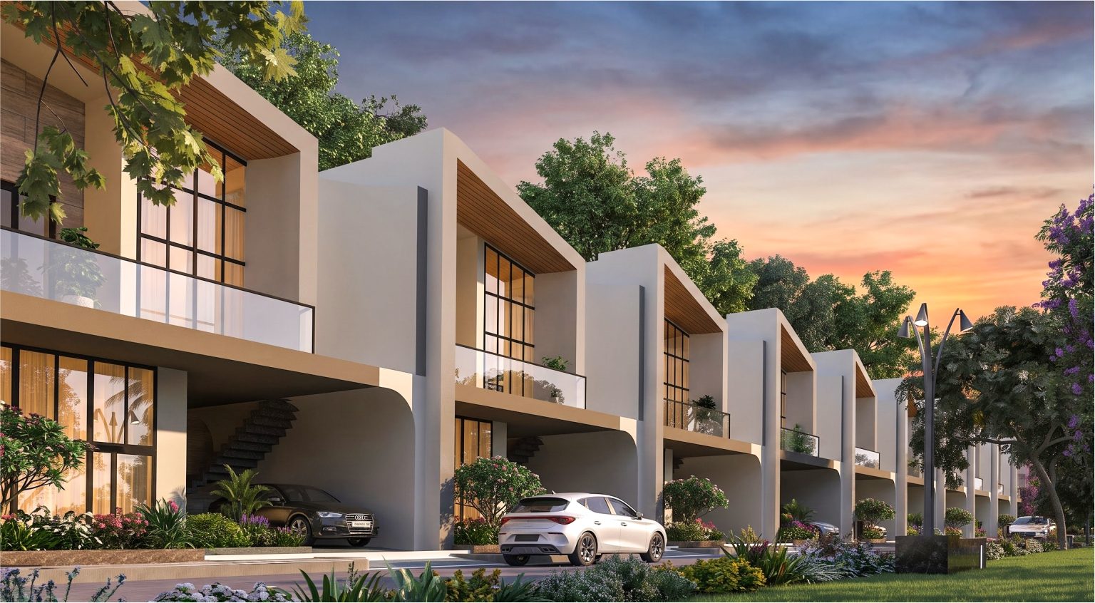 Row of contemporary villas at Shital Palm Greens with balconies and covered parking along a landscaped avenue